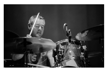 photograph of Bryan St. Pere playing drums