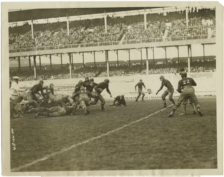 picture from New York Public Library collection. "Cornell's lugubrious coach pessimistic over Columbia victory." from 1923. two football teams playing at the polo grounds.