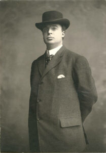 professional photograph of man in suit and hat