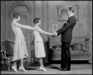 photo still from "The Captive": Man and Woman holding hands, with another woman behind the first woman, hands on her shoulders.