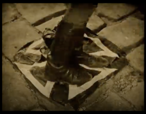 still image from the film "Wings" - a soldiers boots standing/stamping on a flag of the German/Nazi "Iron Cross"