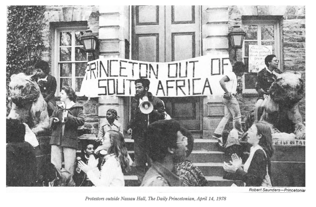 newspaper photograph of students protesting outside campus building, a sign across the doors reads "Princetown out of South Africa" - caption: "Protestors outside Nassau Hall, The Daily Princetonian, April 14, 1978"