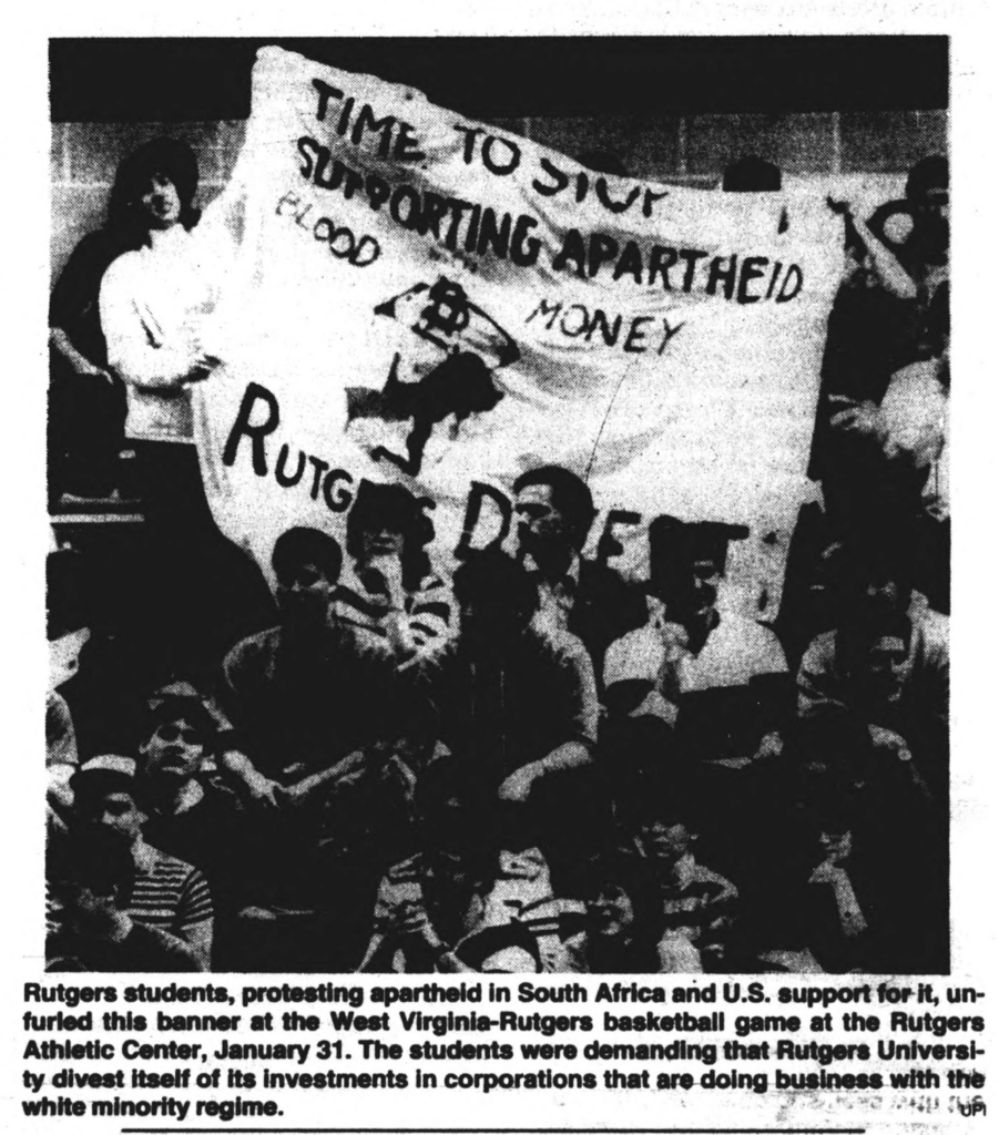newspaper photograph of student protesters holding up a sign reading "Time To Stop Supporting Apartheid Blood Money - Rutgers Divest"