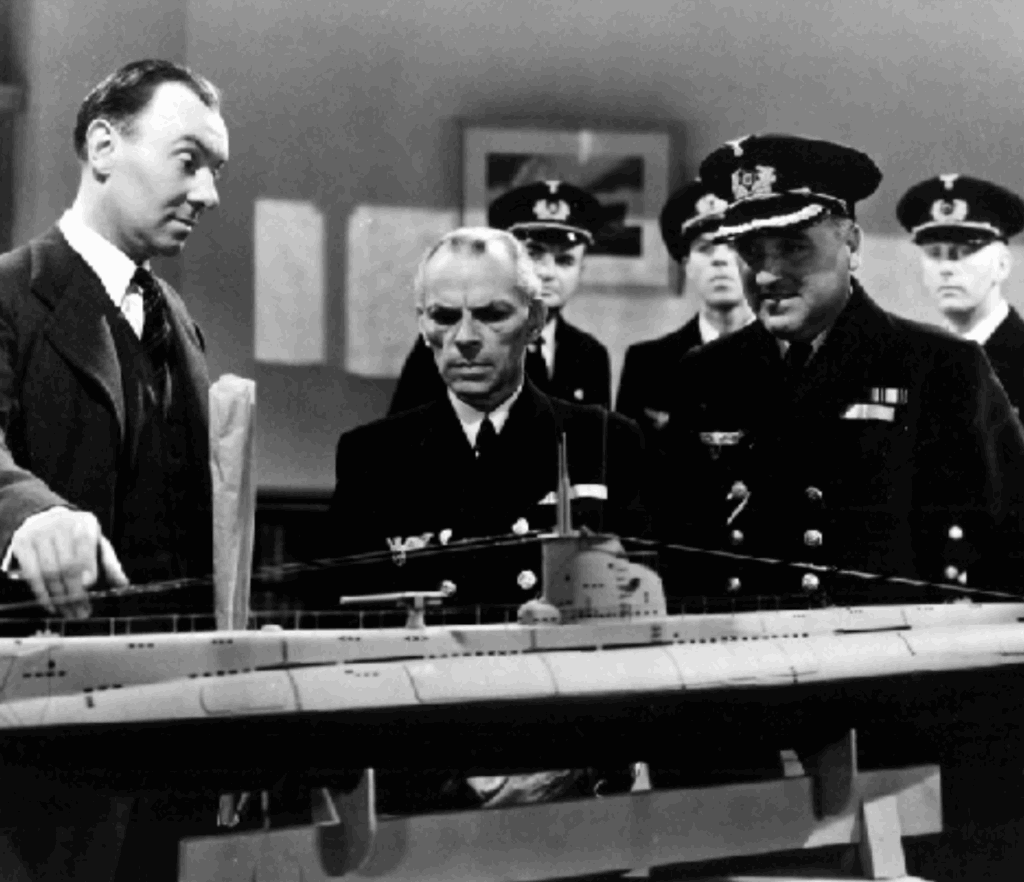 still from The Silver Fleet: Van Leyden shows the occupying Nazis a ship design they will love and that will destroy them.